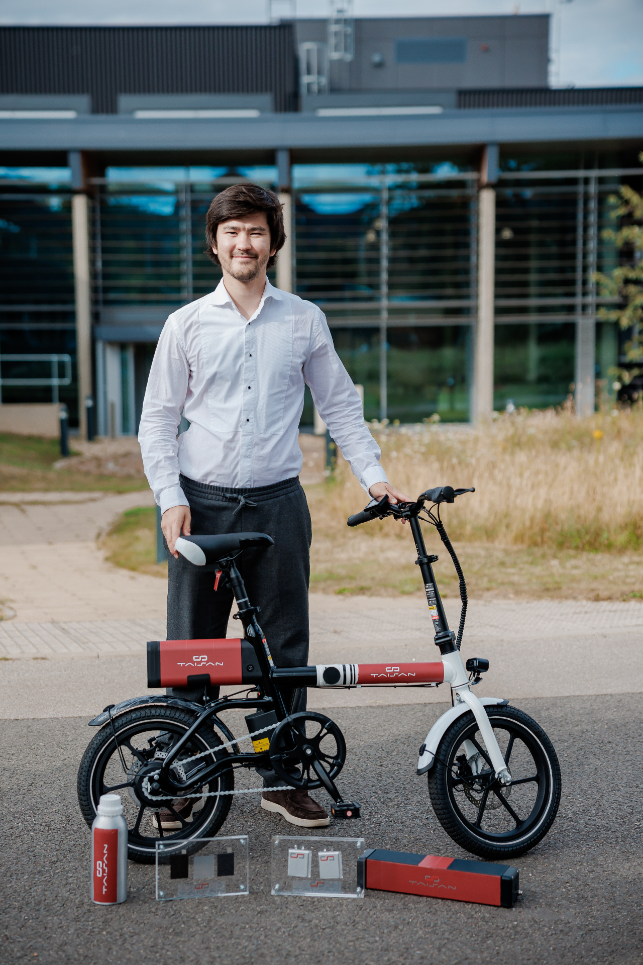 Founder & CEO Sanzhar Taizhan with a TaiSan-powered e-bike and cell samples